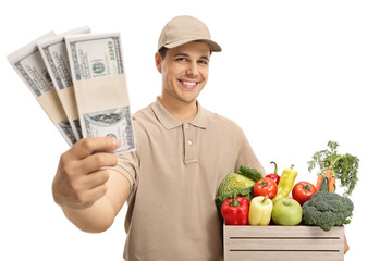 Canvas Print - Delivery man with bundles of money and a crate filled with groceries