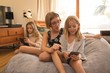 © Wavebreak Media - Siblings using smartphone and digital tablet at home