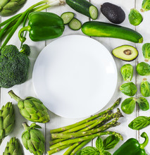 Overhead View Of Green Vegetables Around White Empty Plate