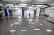 Inside shot of car washing area with glowing lamps reflecting light in wet floor. 