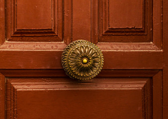 close up on a round door handle with decorative elements, door decoration