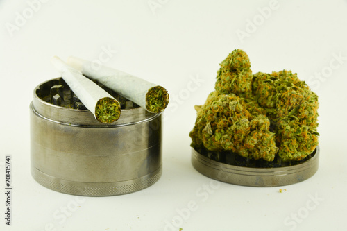 Fotografía Marijuana buds and joints with herb grinder on white background