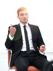 Poster - closeup . businessman talking while sitting in a chair.