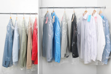 Canvas Print - Racks with clean clothes after dry-cleaning on hangers in wardrobe