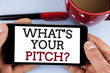 Word writing text What Is Your Pitch Question. Business concept for Present proposal Introducing Project or Product written on Mobile Phone Screen holding by man on the plain background Cup Marker