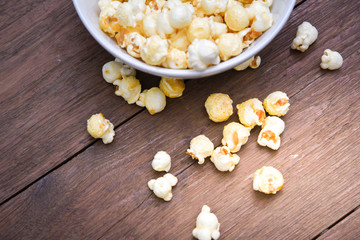 A bowl of popcorn on a wooden table