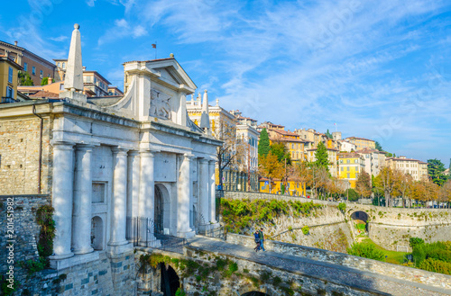 People are walking on a stone bridge towards porta san giacomo in Bergamo, Italy Принти на полотні