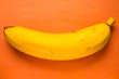 yellow banana on an orange paper background
