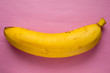 yellow banana on a pink paper background
