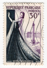 Leeds, England - April 20 2018: An Old Purple French Postage Stamp With An Image Of A Woman In A Dress Celebrating Fashion