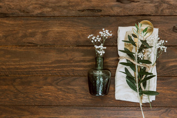 Wall Mural - Flat lay Gold vintage silverware, linen napkin, olive brunch and wedding decorations. Trendy rustic table arrangement