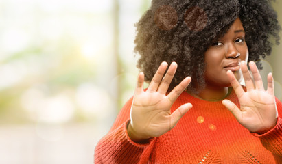 Sticker - Beautiful african woman disgusted and angry, keeping hands in stop gesture, as a defense, shouting, outdoor