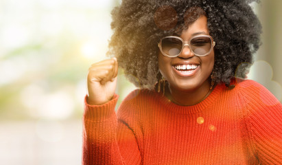 Poster - Beautiful african woman happy and excited celebrating victory expressing big success, power, energy and positive emotions. Celebrates new job joyful, outdoor