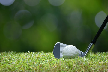 Wall Mural - Golf ball on green grass ready to be struck on golf course background