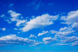 white clouds in a bright blue spring sky