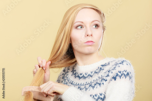 Teenage Blonde Girl Brushing Her Hair With Comb Buy This
