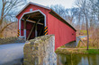 © Fotos 593 - Outdoor view of red covered bridge inside of the forest over a small river in Lancaster