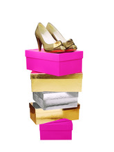 Golden Woman Shoes On Top Of Stacked Boxes Isolated