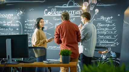 Poster - Female Developer with Tablet Computer Talks With Programer and Project Manager, They use Blackboard Wall as a Planner. They Work in the Stylish Creative Office.