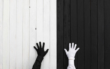 Hands in black and white gloves on a black and white background