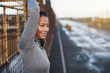 © Flamingo Images - Sporty young Asian woman leaning against a mesh wall outdoors