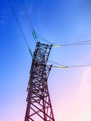 Wall Mural - High voltage electricity pylons and transmission power lines on the blue sky background.