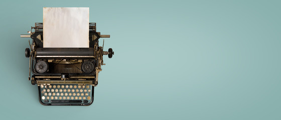 vintage typewriter header with old paper. retro machine technology - top view and creative flat lay 