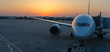 Airplane illuminated by sunset light