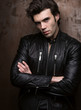 © Bakulov - Portrait of a man in a black leather jacket near wall