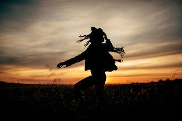 Wall Mural - Boho nomads girl in field at Sunset