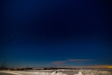Dark Blue Sky And Stars Above The Snowy Plain.