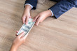 © suphaporn - close up hand of business giving or paying money  US dollar bill