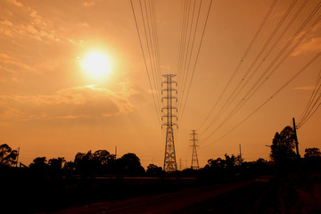 Wall Mural - high voltage poles on the orange sky concept of electric power