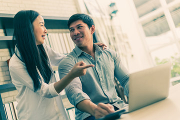 business online marketing with two co worker with box of products in office background