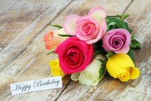 Happy Birthday Card With Colorful Bouquet Of Roses On Rustic Wood
