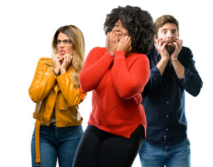 Poster - Group of three young men and women terrified and nervous expressing anxiety and panic gesture, overwhelmed