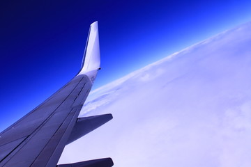 aeroplane wing with blue sky in the distance