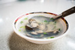 A bowl of Taiwanese clam soup in a night market restaurant.