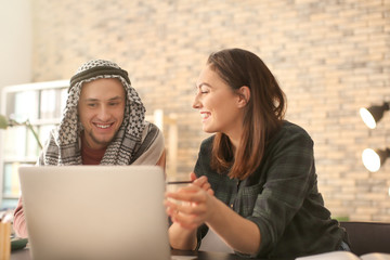 Canvas Print - Female student with her Muslim classmate in library