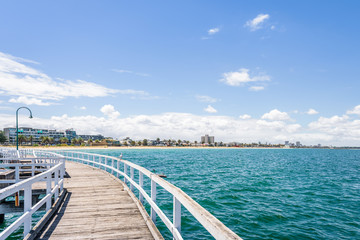 Port Melbourne, Victoria, Australia: Beautiful sunny coast view to australian blue sea and beach port harbour with cruise ship Sprit of Tasmania at shore and white gull jetty to beach bay