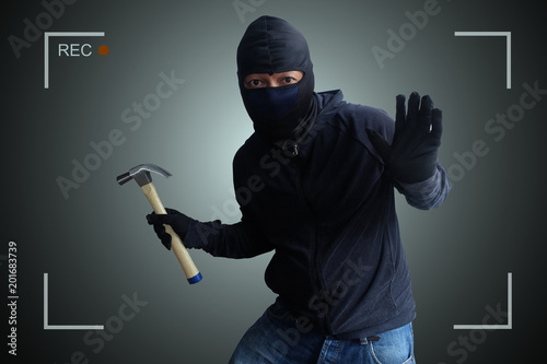 Fotomural Camera capture and record caught Masked thief with hammer at night