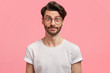 © wayhome.studio  - Portrait of attractive young male model has shocked pleased expression, trendy hairdo, wears round spectacles, hears something unexpected. Stunned student surprised to pass exam successfully