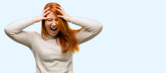 Poster - Beautiful young redhead woman stressful keeping hands on head, terrified in panic, shouting isolated over blue background