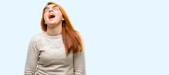 Beautiful young redhead woman confident and happy with a big natural smile laughing isolated over blue background