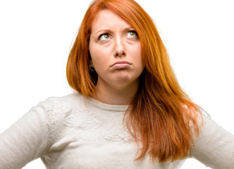 Poster - Beautiful young redhead woman doubt expression, confuse and wonder concept, uncertain future isolated over white background