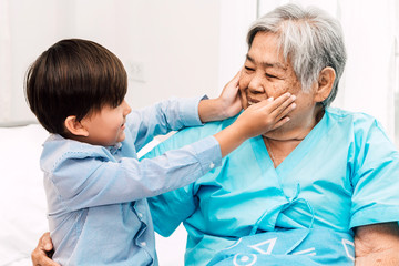 Portrait of happy elderly woman with little grandson smiling.relax family love people concept