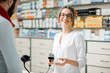 Pharmacist selling medications in the pharmacy store