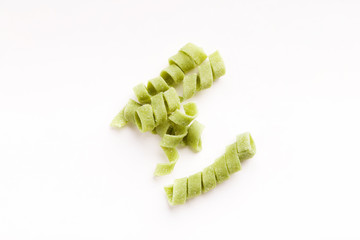 Wall Mural - Pile of raw green fusilli isolated on white