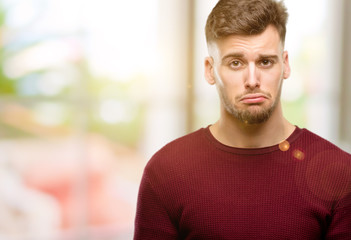 Sticker - Handsome young man with sad and upset expression, unhappy