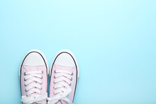 Pair Of Pink Sneakers On Blue Background